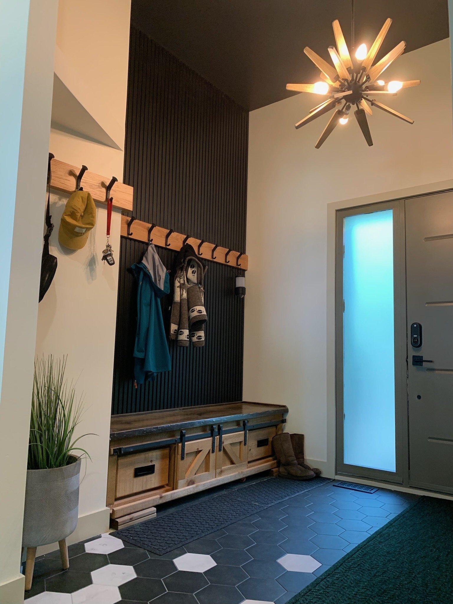 Front door of the cottage with a sunburst chandelier